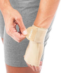 Person adjusting beige Ultimate Hand And Wrist Compression Glove For Men And Women Pain Relief For Carpal Tunnel And Arthritis