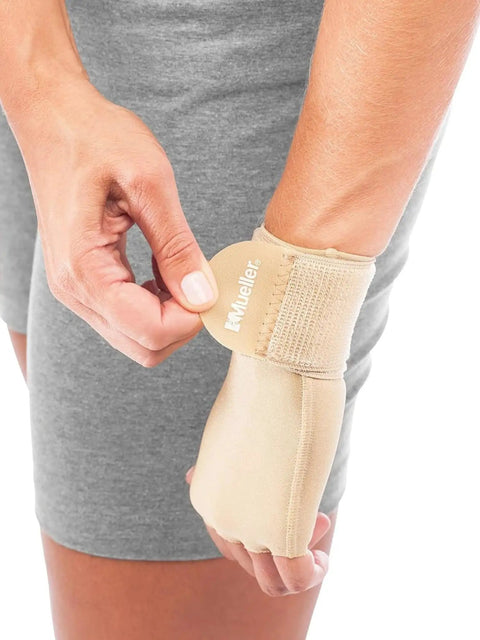 Person adjusting beige Ultimate Hand And Wrist Compression Glove For Men And Women Pain Relief For Carpal Tunnel And Arthritis