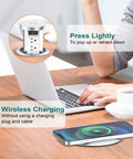Pop Up Power Outlet With Wireless Charging Station in use on a desk, showing wireless phone charging and pop-up feature.