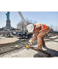 Construction worker using 9 Inch 5/64 By 7/8 T1 Flexvolt Cutoff Wheel For Metal Cutting Tough As Nails Performance by the Statue of Liberty.