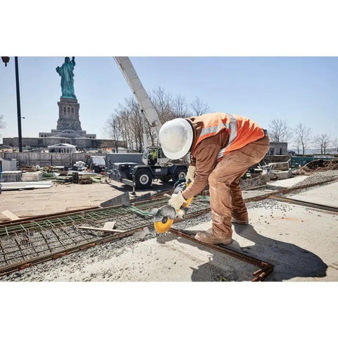 Construction worker using 9 Inch 5/64 By 7/8 T1 Flexvolt Cutoff Wheel For Metal Cutting Tough As Nails Performance by the Statue of Liberty.