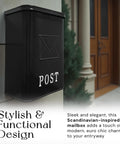 Classic London Style Wall Mount Mailbox In Black Matte Finish Outdoor Front Door Mailbox Weather Resistant Covered Mailbox For Outside Wall 9.5 x 4.72 x 14.96 Inches Old School Charm For Modern Homes, mounted on exterior wall next to brown door.