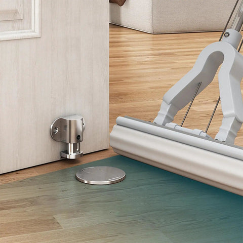 Heavy Duty Stainless Steel Door Stopper Floor Mount with Nails or Sticker Grip, installed near a door on wooden floor.