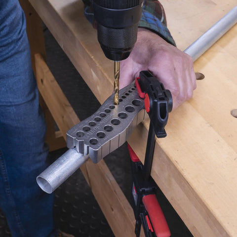 Using all metal handheld drill guide for straight holes with twenty five drill guides in one eighth to one half inch increments
