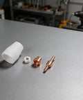 32Piece Plasma Cutter Consumable Kit With Nozzles Electrodes Ceramic Rings on metal surface