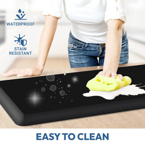 Extra Thick Anti Fatigue Kitchen Mat Cushioned Floor Rug For Standing Comfort Grippy Non Slip Water Resistant Easy To Clean 17 By 24 Inch Black Kitchen And Sink Mat For Home Office being cleaned with a cloth.