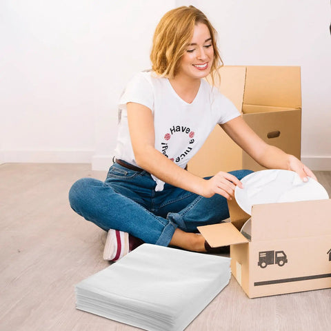 Woman packing dishes with 100 Pack White EPE Foam Packing Pouches For Fragile Items Protection with boxes in the background