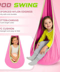 Child sitting in a pink pod swing with a sensory swing stand frame visible, highlighting durable nylon and cotton-canvas materials.