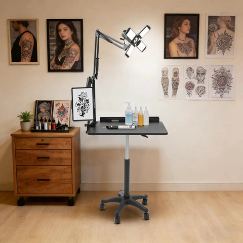 Smooth Rolling Adjustable Height Tattoo Workstation With Bright Led Panel And Smart Storage Rack For Your Professional Mobile Art Studio Daily Grind And Heavy Duty Gear, set up with art supplies and references.