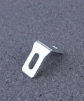 Close-up of a white plastic bracket from the 28 Pack White Plastic Corner Brackets For Furniture Reinforcement Anti Slip Desk And Chair Corner Braces