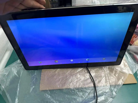 Heavy Duty 15.6 Inch Industrial Tablet Pc Featuring Tough As Nails Android Touchscreen showing a blue screen, placed on a table.
