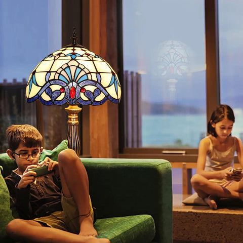 Vintage White Stained Glass Tiffany Style Table Lamp With LED Bulbs Included, illuminating a cozy living room scene.