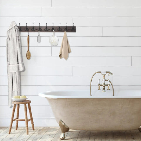 Rustic 34 Inch Wall Mounted Coat Rack With Ten Decorative Hooks Heavy Duty Pine Wood Rail For Entryway Or Living Room Holds Up To 15 Lbs Per Hook Old Wood Color Farmhouse Style installed in bathroom with bathtub.