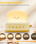 Toaster Shaped LED Table Lamp With Rechargeable Battery Nightstand Light With Timer Cute Toast Bread Bedroom Lamp For Kids Babies Boys And Girls Cozy Ambient Glow And Great Birthday Gift. Lamp adjusts brightness freely with a smiling toast design.
