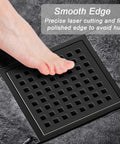 Foot on 6 Inch Square Shower Drain With ABS Flange Base In Matte Black 304 Stainless Steel High Flow Floor Drain Removable Grate.