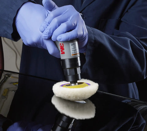 Person using Perfect-It Paint Finishing Pad Kit for Small Areas, 4 inch single sided, with foam and low-lint wool on car surface.