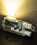 Rechargeable EDC Flashlight With USB C 700 Lumen Dope Keychain Light emitting beam, batteries visible on dark surface