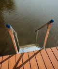 Heavy Duty Aluminum Dock Stairs With Five Wide Platforms And Twin Handrails. Dockside view showing sturdy stairs into the water.