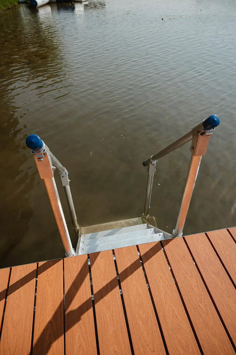 Heavy Duty Aluminum Dock Stairs With Five Wide Platforms And Twin Handrails. Dockside view showing sturdy stairs into the water.