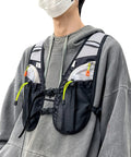 Person wearing hydration vest for outdoor adventures with easy access water bladder, reflective front chest pocket, multiple storage pockets.