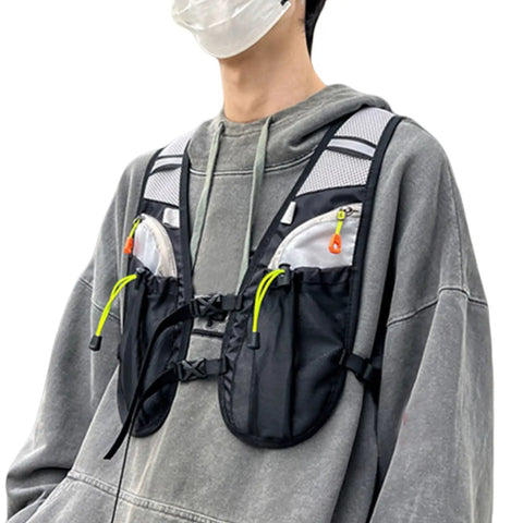 Person wearing hydration vest for outdoor adventures with easy access water bladder, reflective front chest pocket, multiple storage pockets.