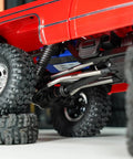 Beefed Up Steel High Clearance Chassis Links For TRX4M High Trail K10 F150 RC Crawler with red body on rocky terrain