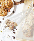 Cone Shaped OPP Plastic Bags For Candy And Popcorn holding cookies, showcasing clear triangular design, perfect for gifts and snacks.