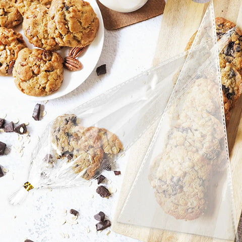 Cone Shaped OPP Plastic Bags For Candy And Popcorn holding cookies, showcasing clear triangular design, perfect for gifts and snacks.