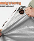 Person demonstrating the strength of Heavy Duty 8x10 Ft Tarp Waterproof 10 Mil Thick Reversible Silver And Brown Outdoor Cover