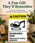 Rugged Aluminum Construction Area Warning Sign 8x12 Inch with excavator icon on a table with plants and gifts.