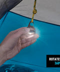 Hand holding Moonlit Rechargeable Micro Lantern For Camping And Hiking inside a tent, showing 360-degree swivel