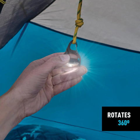 Hand holding Moonlit Rechargeable Micro Lantern For Camping And Hiking inside a tent, showing 360-degree swivel