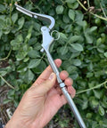 Hand holding Heavy Duty Quick Release Pelican Hook Shackle for Quarter Inch Wire Rope on Boats and Yachts, 316 stainless steel