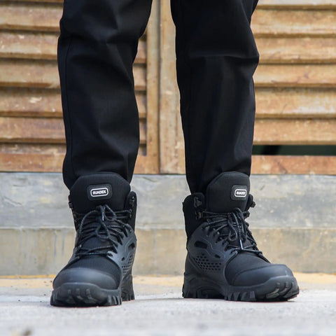 Person wearing indestructible steel toe work boots for men and women waterproof built tough with arch support and non-slip rubber sole.