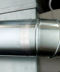High-temperature flue tape on a galvanized HVAC duct seam (side view)