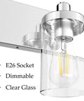 Close-up of Two Light Chrome Vanity Light Fixture With Clear Glass Shades and stainless steel wall sconce.