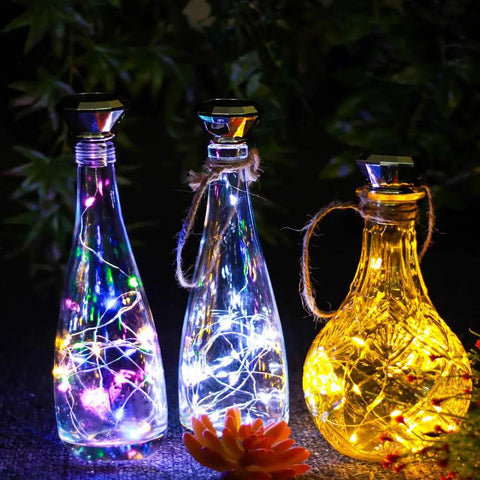 Solar Diamond Wine Bottle Lights 10 Pack with 20 LEDs Outdoor Waterproof Multicolor Fairy String Lights glowing in bottles.