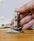 Hand using Galvanized Steel Drywall Toggle Anchors Kit For Heavy Duty Wall Fixings And DIY Installation Toggle Wing Nut Fasteners