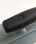 Close-up of Lightweight Plastic Trowel With Black Comfort Grip Workhorse for easy scrape and smooth walls, black handle detail.