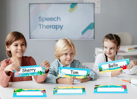 Children holding 36 Sea Animals Desk Name Plates For Classroom Kid Friendly Personalized Name Tags For Kids And Students Adhesive Labels