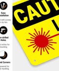 Laser In Use Sign Caution Sign 10x7 Inches Rust Free Aluminum Fade Resistant Indoor Outdoor Safety Sign For Shops And Factories And Industrial Spaces Made In USA, close-up of yellow sign with pre-drilled holes and laser symbol