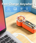 Beast Portable Handheld Fan On The Go With USB-C Rechargeable Battery next to laptop on wooden table.