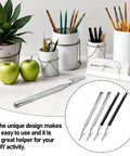 Stainless Steel Alligator Clips Set With Telescopic Wire Clamps and Pen Clip shown on a creative workspace table