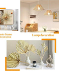 Decorative home accessories including a photo frame, hanging lamps, and a vase with golden leaves.