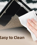 Hand wiping a rug corner showing Eight Pack Non Slip Rug Grippers For Area Rugs Double Sided Rug Pads Corner Tape For Hardwood Floors