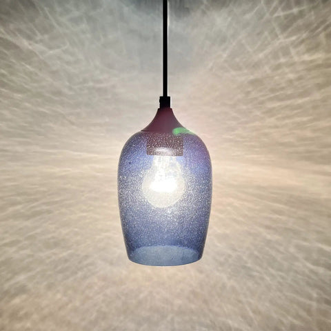 Close-up of a single pendant light from Three Pack Pendant Lights Set for Kitchen Island Hand Blown Seeded Blue Glass Shades in Black Finish.