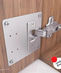 Stainless door hinge repair plate kit installed on kitchen cabinet, part of Door Hinge Repair Plate for Kitchen Cabinets and Furniture.