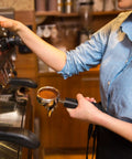 Barista using espresso machine with portafilter in hand, preparing to use Espresso Coffee Stirrer Tamper And Needle Type WDT Distribution Tool
