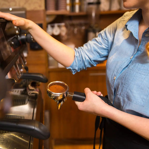 Barista using espresso machine with portafilter in hand, preparing to use Espresso Coffee Stirrer Tamper And Needle Type WDT Distribution Tool