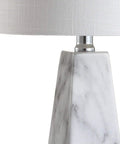 Close-up of White Marble Look Resin Table Lamp With Faceted Contemporary Design, cool bedside lamp showing base texture and linen shade.
